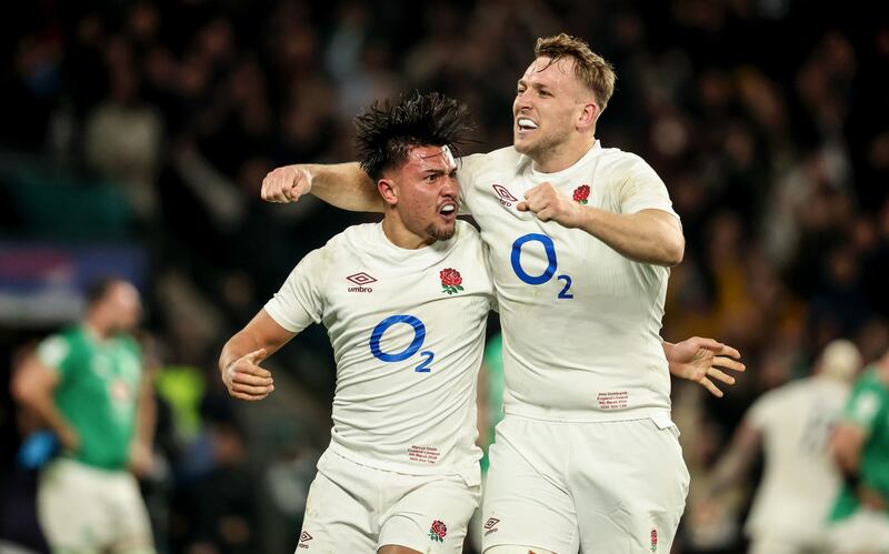 England’s Marcus Smith celebrates kicking the winning drop goal with Alex Dombrandt. Photograph: Dan Sheridan/Inpho 
