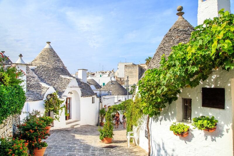 Wander the quaint streets of Alberobello in Italy’s Apulia region, known for its trulli, whitewashed stone huts with conical roofs