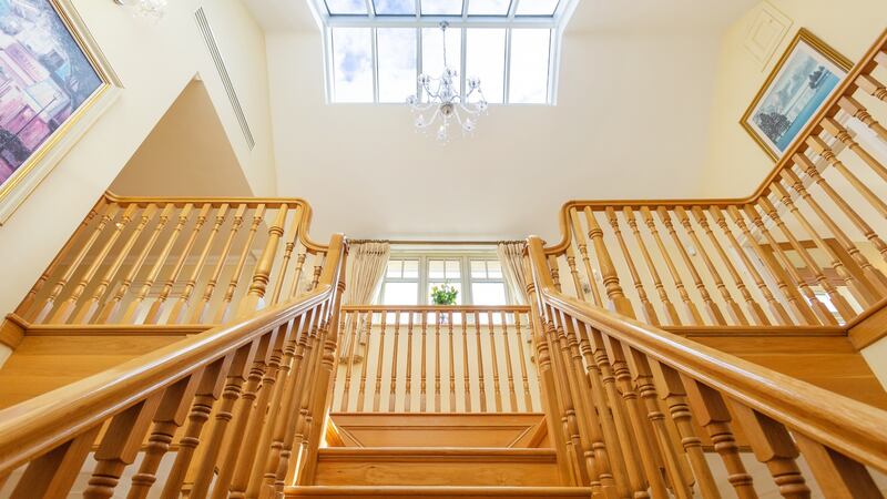 The property features a striking custom oak staircase