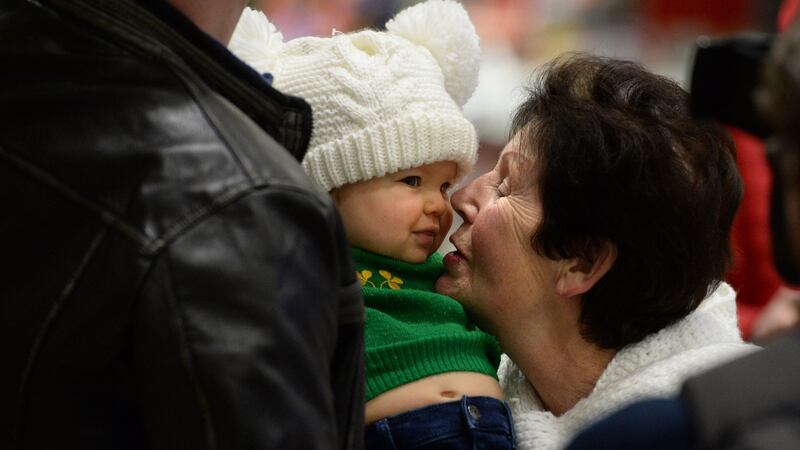 Catherine O’Carroll, from Raheny, meeting her great-granddaughter  Charlotte (10 months)  at Dublin Airport. Photograph: Dara Mac Dónaill