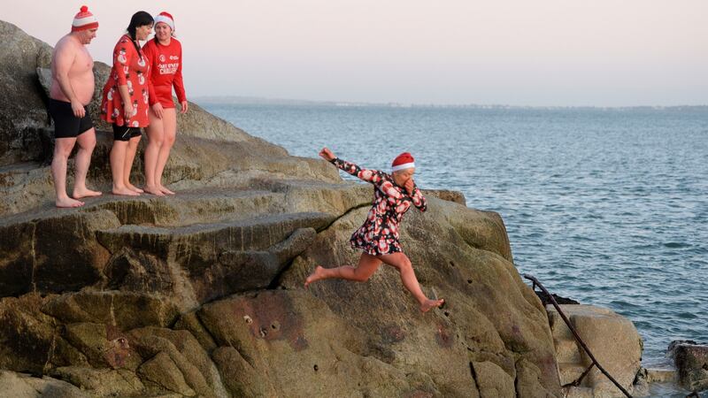 Brigid Brady, (right) taking a leap during a Christmas swim at the forty foot, Sandycove, Co Dublin on Christmas morning. Photograph: Dara Mac Dónaill