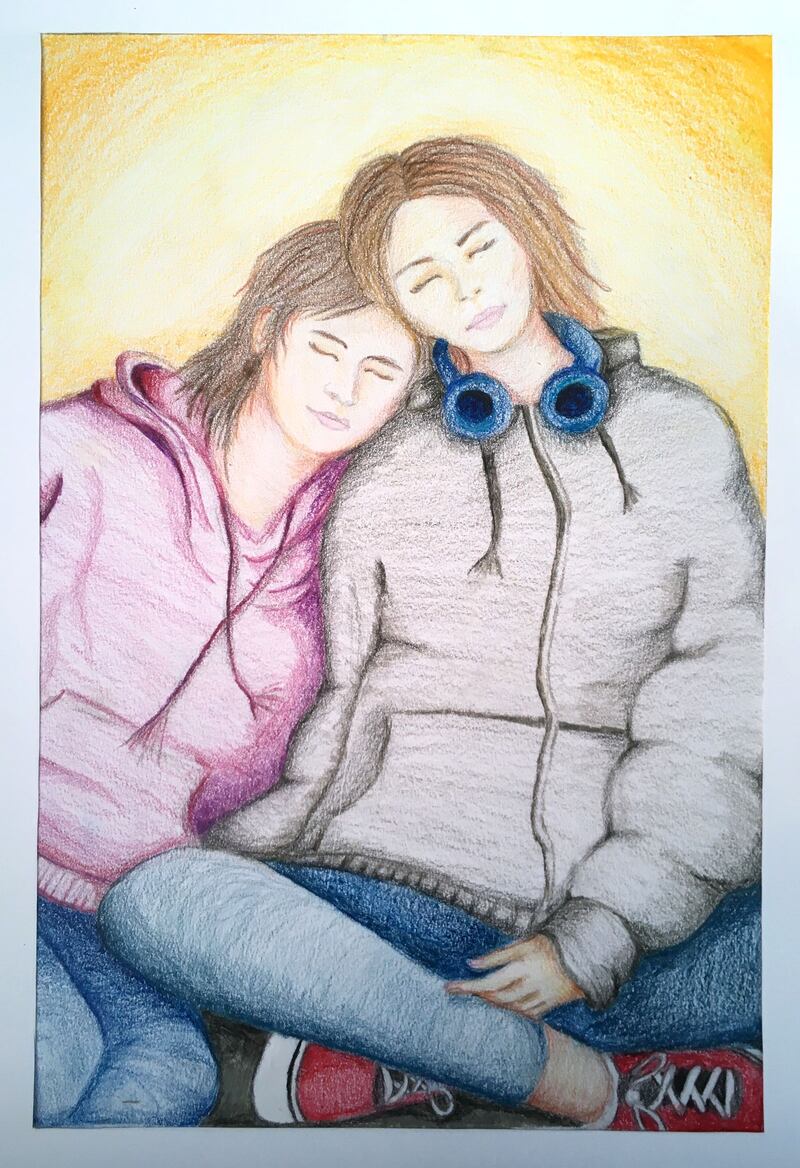 Abaigh Roarty, aged 13.
I got inspiration to create this drawing because during this quarantine it has taught me to appreciate the people around us. The drawing is inspired by a photo of myself and my sister after coming out of the cinema, one of our favourite things to do together. My sister Clara has a learning disability called Angelman syndrome, she also can’t speak. She’s had to get used to us not going out to the cinema, restaurants and school, but is coping well with that.  During isolation it has given me a chance to spend more time with my parents.  But sadly, my mother has tested positive for COVID-19 so she has to self isolate for 14 days, we’re all getting used to that and it is quite lonely in the house without her.