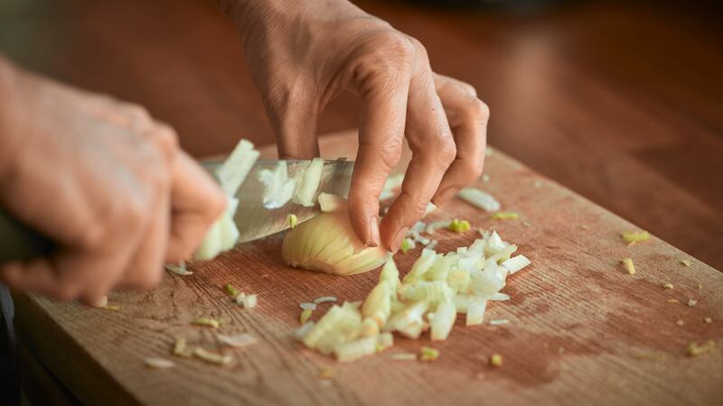 Rinse your knife and the onion in water, you will cry less