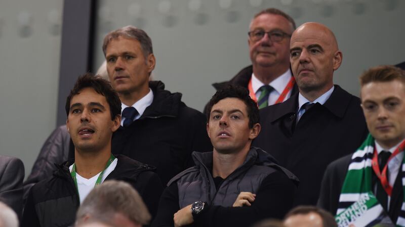 Rory McIlroy pictured in the stand of the Northern Ireland game against San Marino with Fifa president Gianni Infantino and former Dutch striker Marco van Basten (back left). Photograph:  Clodagh Kilcoyne/Reuters/Livepic