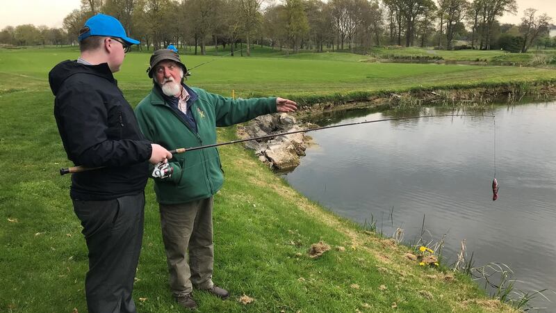 Fourth-year student Adam Kealy (16) learning to cast with tutor Brian McDonagh at the pike lake in the K Club