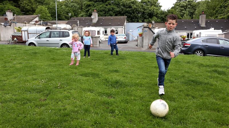 Children playing in the green area at the halting site. Photograph: Joe O’Shaughnessy