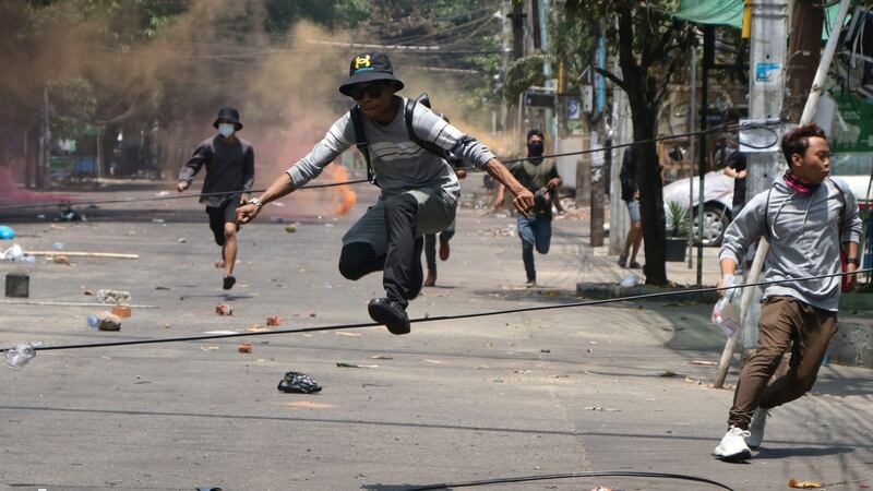 Anti-coup protesters flee from military forces during a demonstration in Yangon, Myanmar, in 2021. Photograph: AP