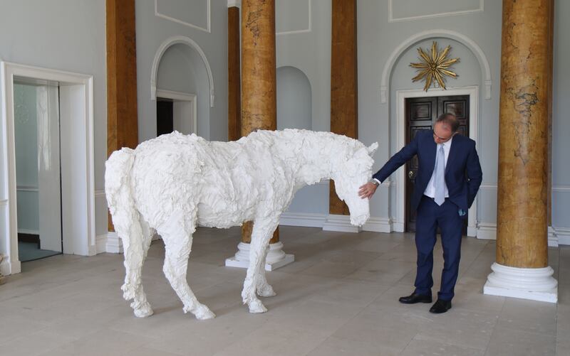 Italian ambassador to Ireland Ruggero Corriasa alongside Davide Rivalta’s startling white fibreglass horse in the front hall of Lucan House. Photograph: Bryan O'Brien