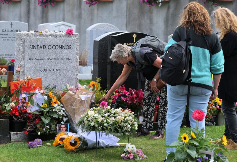 Fans pay their respects at Sinead O'Connor's grave in Deans Grange Cemetery, Dublin, on the one-year anniversary of her death late last month. Photograph: Colin Keegan/Collins
