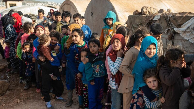 Displaced Syrian children wait in queue to receive humanitarian aid supplied  in Idlib. Photograph: Burak Kara/Getty Images