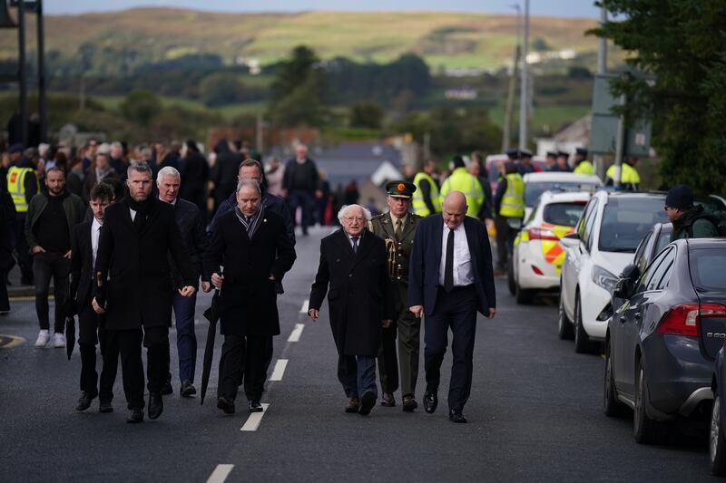 President Michael D Higgins (centre) leaves St Michael's Church, in Creeslough, after the funeral mass of Robert Garwe and his five-year-old daughter Shauna Flanagan Garwe. Photograph: Niall Carson/PA