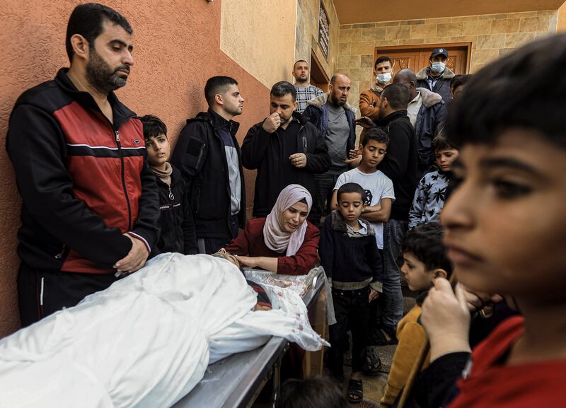 Palestinians in Khan Younis, southern Gaza, mourning relatives killed by Israeli air strikes in the first hours after the temporary ceasefire ended. Photograph: Yousef Masoud/The New York Times
                      