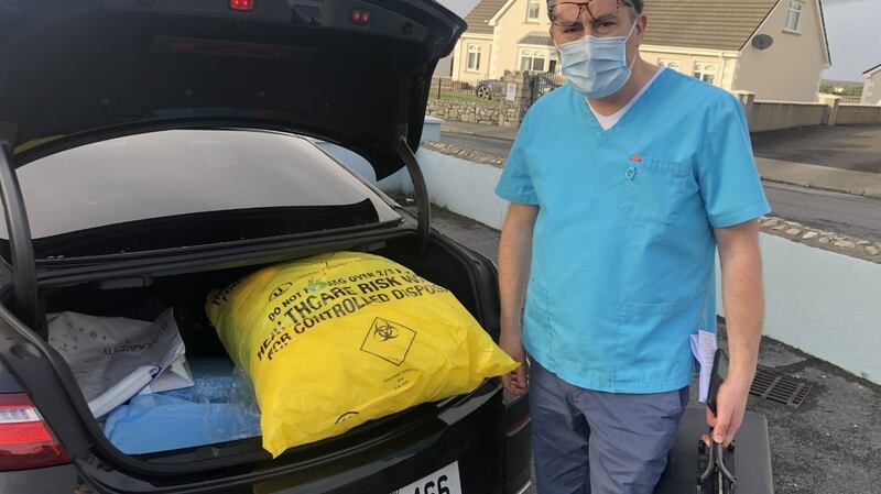 Dr Keith Swanick, Belmullet Co Mayo GP prepares to dispose of PPE equipment after another Covid house call. “I’ve been qualified 23 years and I’ve never worked as hard,”. Photograph: Peter Murtagh