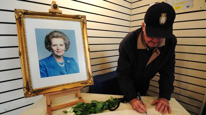 A member of the public signs a book of condolence under a portrait of former prime minister Margaret Thatcher at the Grantham Museum in her hometown Grantham. Photograph: Rui Vieira/PA Wire