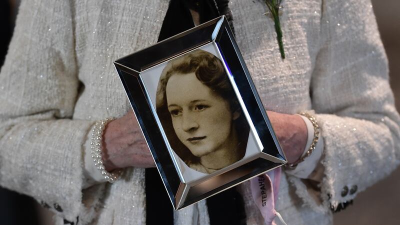 A family member of Joan Connolly holds a photograph of Joan after the findings of the Ballymurphy inquest were revealed at the Waterfront Hall in Belfast on Tuesday. Photograph: Charles McQuillan/Getty