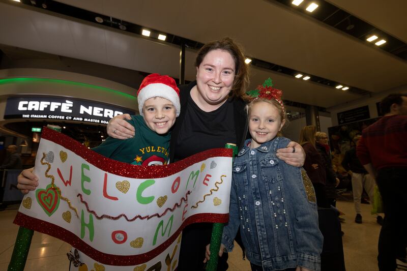 Harry and Heather Kingston from Drogheda welcoming their Aunt Mary home from Pennsylvania for Christmas  at Dublin Airport. Photograph: Alan Betson / The Irish Times

