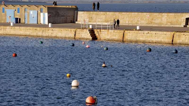 Walkers on the pier at Howth: the RNLI has warned the public to check weather conditions and tides as conditions can ‘change quickly’. File photograph: The Irish Times