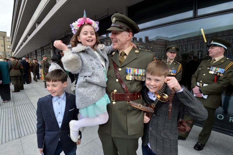 Lieut Colin McNamara is congratulated by his children Conor, Aoibh and Rian after being commissioned as an officer. Photograph: Alan Betson/The Irish Times
