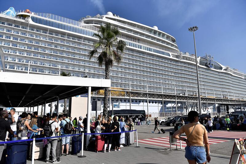 Tourists wait for taxis after disembarking from a cruise ship at Barcelona's harbour. Some 400,000 cruise passengers who disembark in the port every month in high season. Photograph: Pau Barrena/AFP via Getty Images