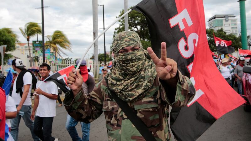 A masked pro-government supporter takes part in a march in support of Nicaraguan president Daniel Ortega in Managua on August 18th. Photograph: Oswaldo Rivas/Reuters