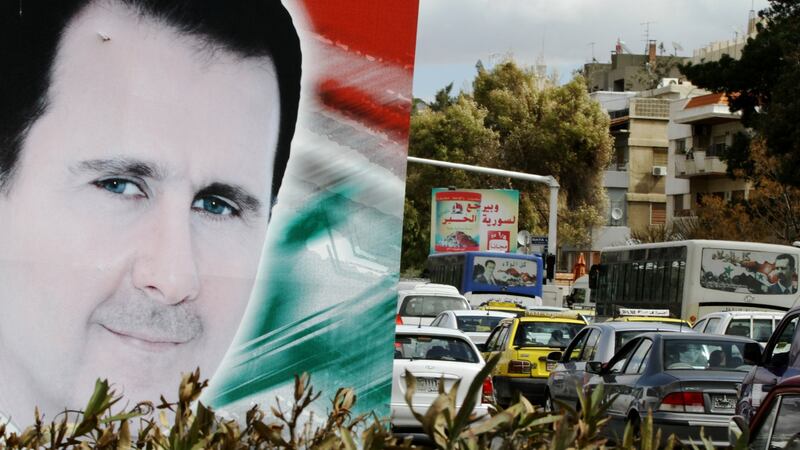 A banner bearing a portrait of Bashar al-Assad in a street in  Damascus in March 2015. Photograph: Louai Beshara/AFP/Getty Images