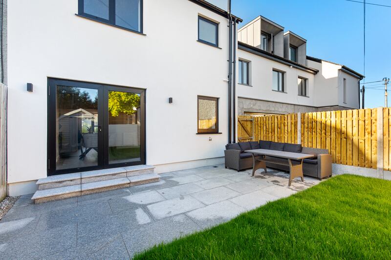 The back garden has patio, lawn, flower beds, garden furniture and a shed