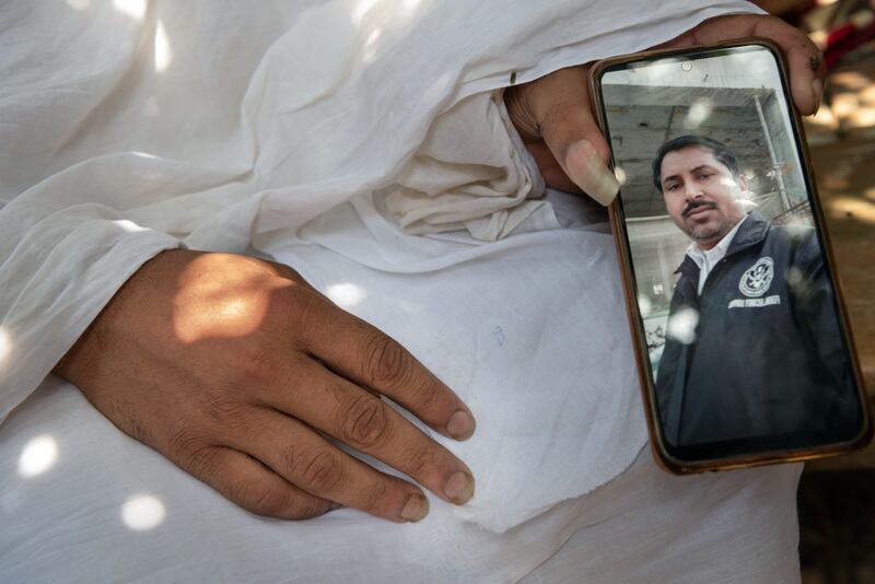Ram Bikash displays a photo of his late father, Rakesh Kumar Yadav, in Dhamaura, Nepal. Photograph: Saumya Khandelwal/New York Times