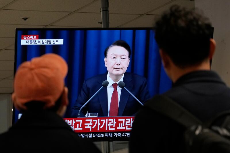 People at a bus terminal in Seoul watch a TV screen showing South Korean president Yoon Suk Yeol’s televised briefing, in which he declared martial law. Photograph: Ahn Young-joon/AP