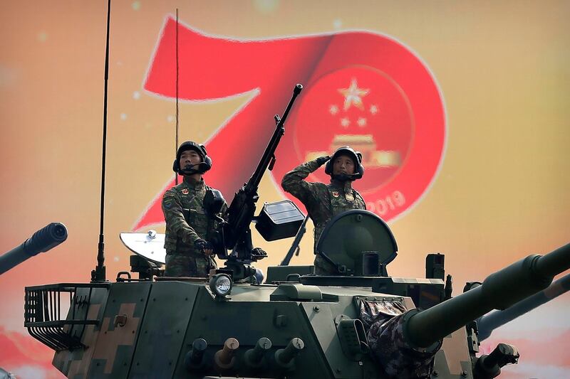 Chinese tank crew members salute during the parade. Photograph: Mark Schiefelbein/AP