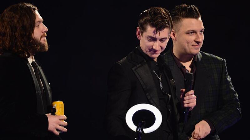 Alex Turner of Arctic Monkeys receives the award for Best British Group at The Brit Awards 2014 at 02 Arena in London last night. Photograph:  Ian Gavan/Getty Images.