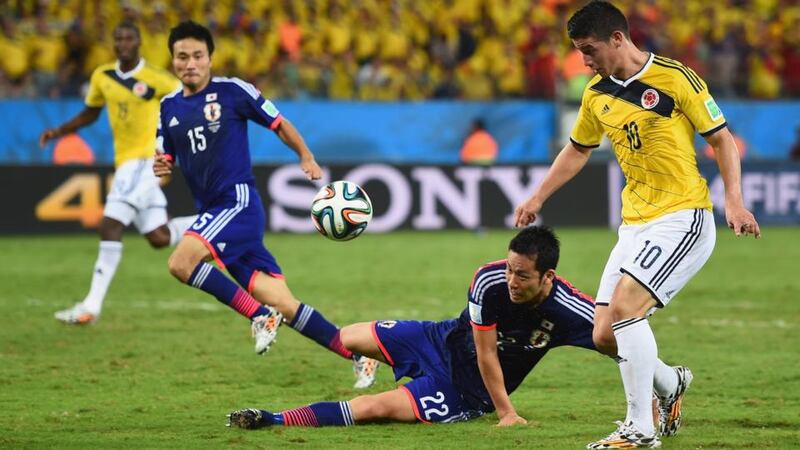 James Rodriguez of Colombia chips  his team’s fourth goal against Japan at Arena Pantanal in Cuiaba. Photograph:   Christopher Lee/Getty Images