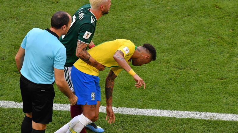 Mexico’s defender Miguel Layun picks up Neymar during his side’s defeat to Brazil. Photograph: Saeed Khan/AFP/Getty