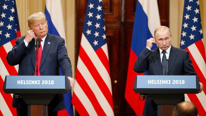 US president Donald Trump  and Russian president Vladimir Putin adjust their earpiece plugs during a joint press conference following their summit talks  in Helsinki, Finland. Photograph: Anatoly Maltse/EPA