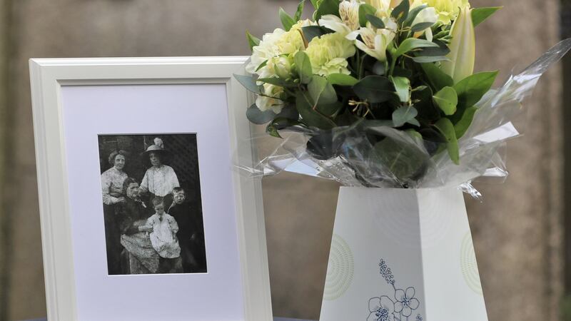A photograph of  Eugene Lynch (right) with his relatives Anna Marie Lynch, (back left); Elizabeth McGrath (sitting); Nicholas; and Mary McGrath (back right) at his grave in Goldenbridge Cemetery. Photograph: Colin Keegan/Collins.