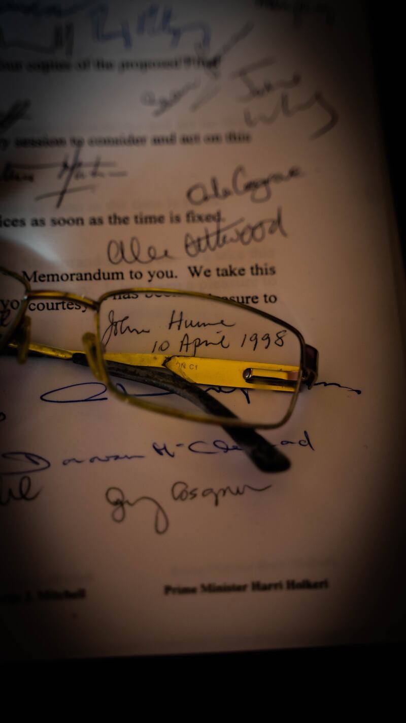 Hume: Beyond Belief – John Hume’s glasses on an original signed copy of the Belfast Agreement