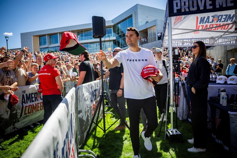 Charlie Kirk hands out hats before speaking at Utah Valley University. Photograph: Tess Crowley/The Deseret News/AP