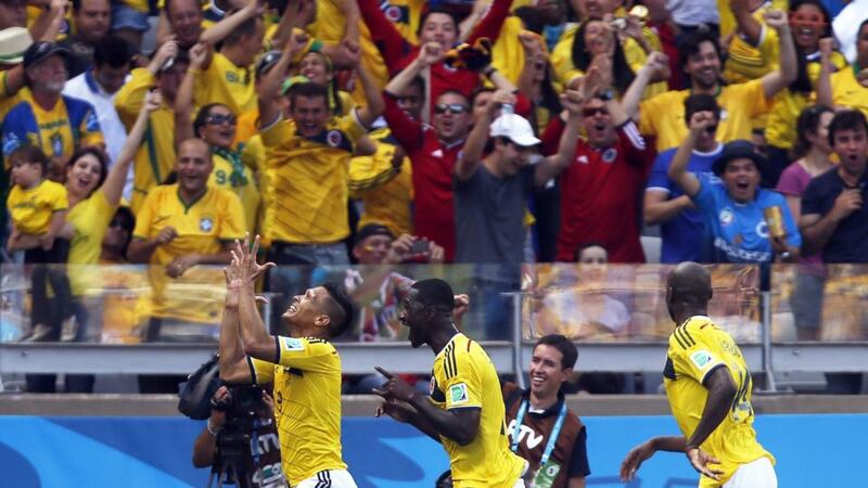 Colombia’s Teofilo Gutierrez (left) celebrates his 2-0 goal with Juan Cuadrado (centre) and Victor Ibarbo (right)  at the Estadio Mineirao in Belo Horizonte. Photograph: Felipe Trueba / EPA