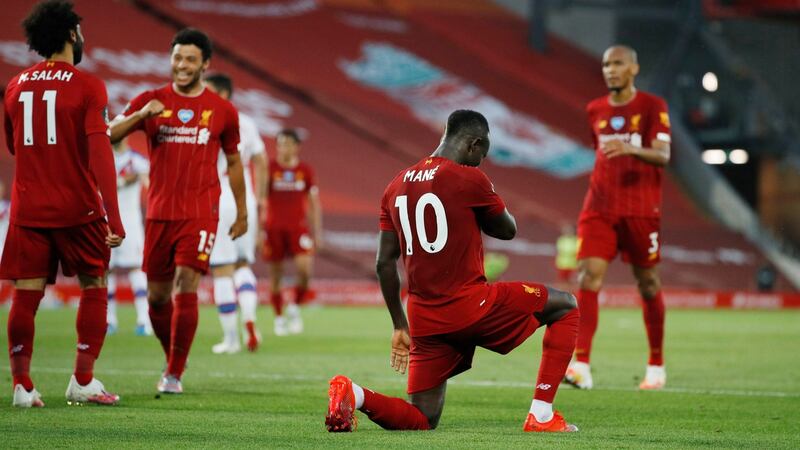 Sadio Mané takes a knee after scoring Liverpool’s fourth goal in the Premier League game against Crystal Palace at Anfield. Photograph: Phil Noble/Pool via Getty Images
