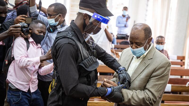 Hotel Rwanda hero Paul Rusesabagina  is handcuffed by a police officer after his pre-trial court session  in Kigali, Rwanda, on September 14th last. Photograph: AFP via Getty Images