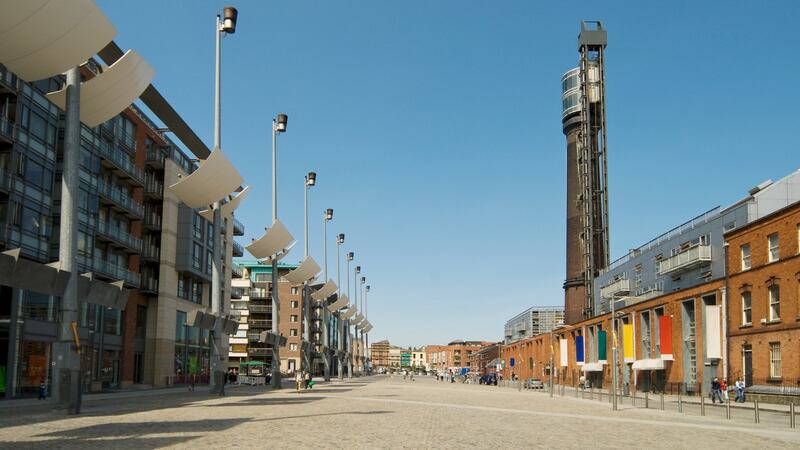 Smithfield Square: teenagers keep to the edge of the redeveloped plaza, away from its eerily quiet centre. Photograph: Image Source/Getty