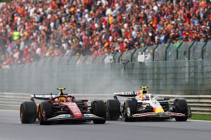 Lewis Hamilton's Ferrari (left) battles for track position with Liam Lawson of Racing Bulls during the Belgian Grand Prix. Photograph: Ryan Pierse/Getty Images