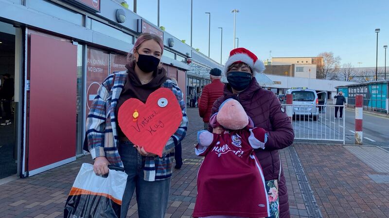 Ellen Hession (left) was greeted outside Dublin airport with a teddy bear and a handmade ‘virtual hug’ heart-shaped sign from her mother when she arrived home. Photograph: Jade Wilson