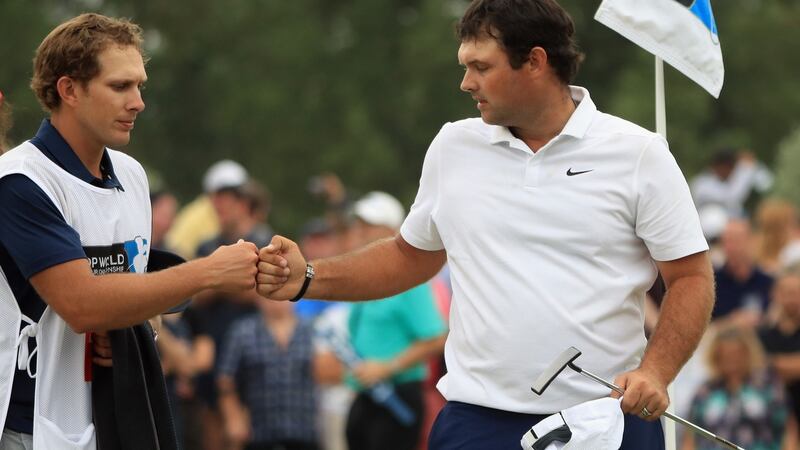 Patrick Reed with his caddie Kessler Karain on the 18th hole at Jumeirah Golf Estates. Photograph: Andrew Redington/Getty Images