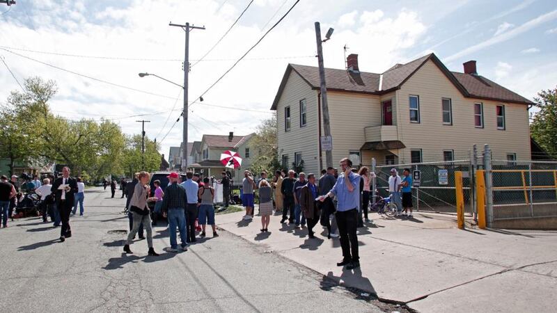 People gather along Seymour Avenue near the house where three women, who disappeared as teens about a decade ago, were found alive. Photograph: Bill Pugliano/Getty Images
