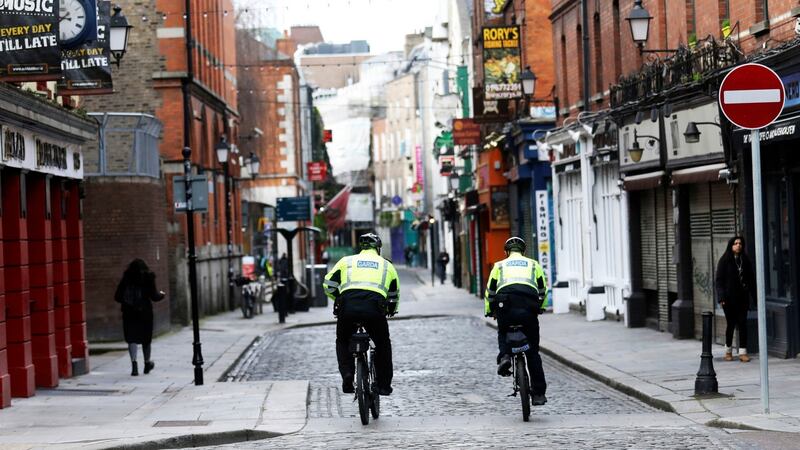 Gardaí patrol a deserted Temple Bar on St Patrick’s Day: whole sectors of the economy remain on taxpayer-funded life support.   Photograph: Peter Morrison