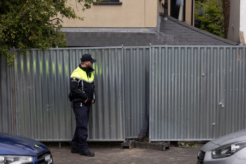 A member of An Garda Síochána at house in Clondalkin, west Dublin where a search took place as part of the investigation into the case of Annie McCarrick. Photograph: Sam Boal/Collins