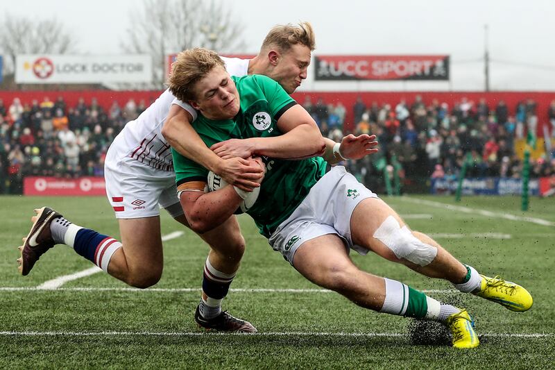 Ireland's Hugh Gavin scores the opening try despite the attempted tackle from Sam Harris of England during the Under-20 Six Nations match at Musgrave Park. Photograph: Ben Brady/Inpho