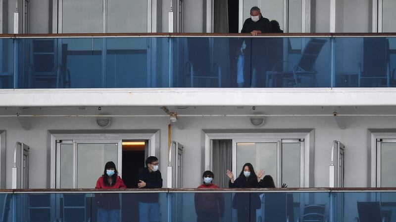 Passengers look out from the balconies of the Diamond Princess cruise ship in Yokohama on Wednesday. Photograph: Charly Triballeau/AFP via Getty Images
