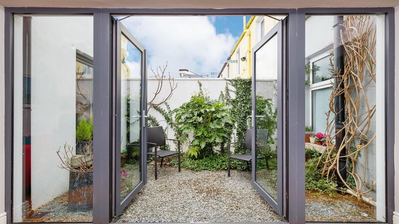 The dining area opens out to a small city garden.