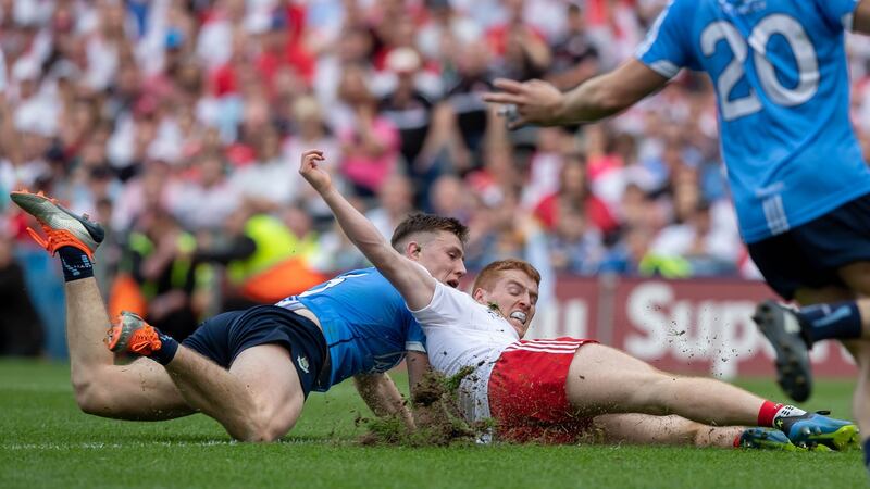 John Small tackles Peter Harte during the 2018 final. Photo: Morgan Treacy/Inpho
